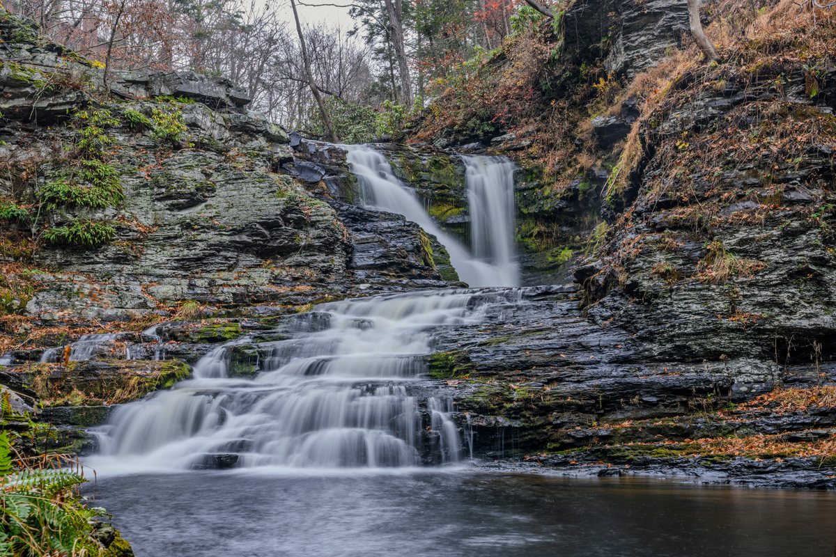 Close view of the natural waterfall cascading over layered rock near Waterfall Wonder.