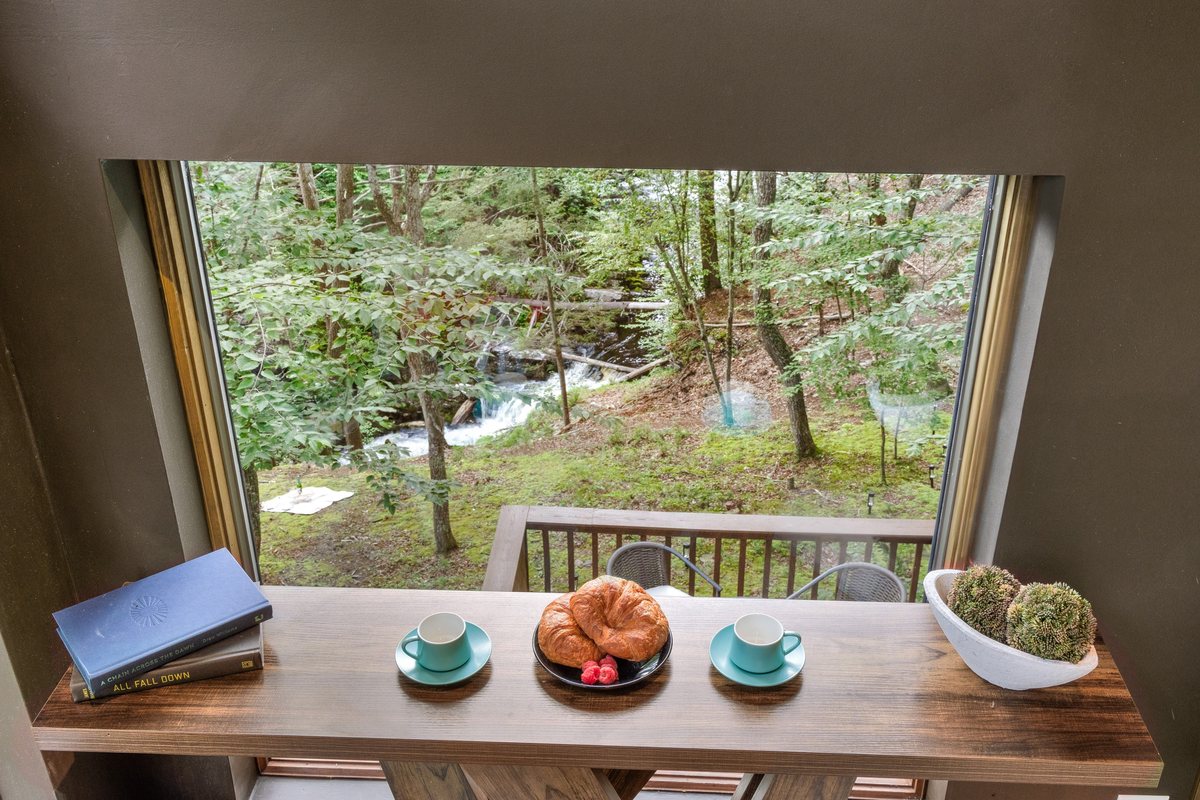 Waterfall and creek view from a window nook inside Waterfall Wonder.