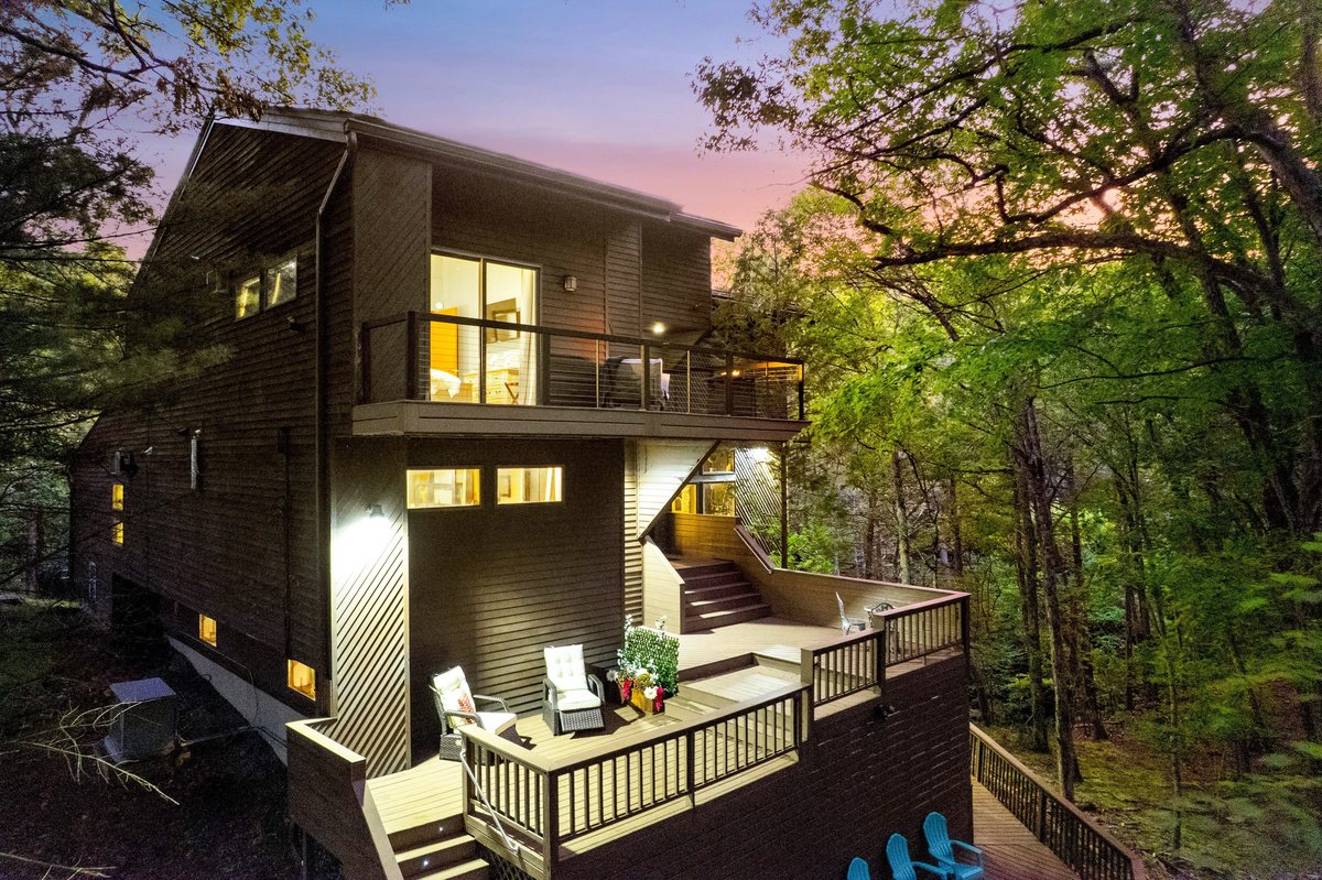 Exterior decks of the Poconos cabin glowing at dusk.