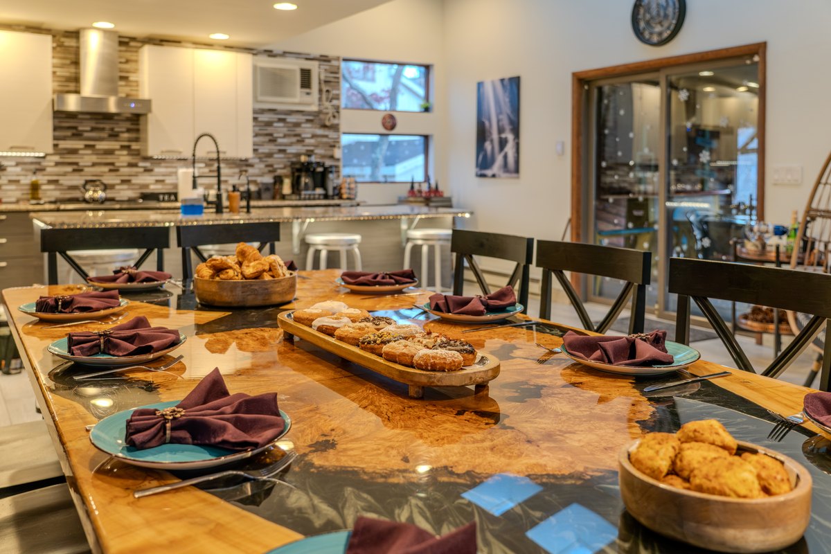 Dining table and kitchen set up for a group meal at Waterfall Wonder.