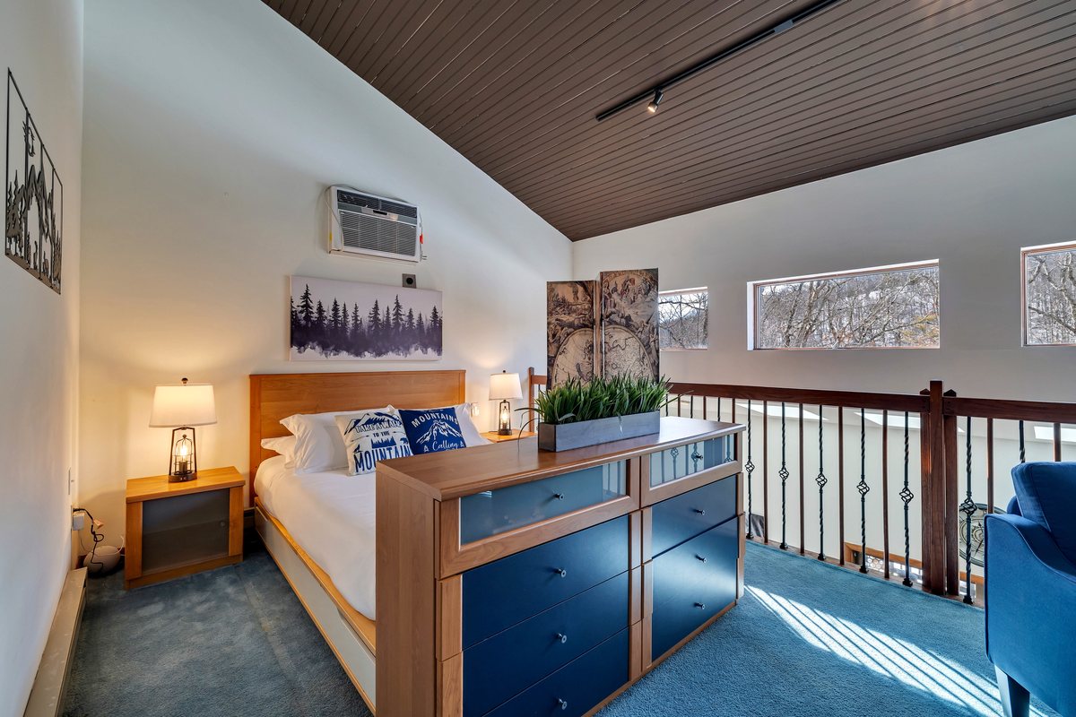 Loft open sleeping area at Waterfall Wonder with a queen bed.